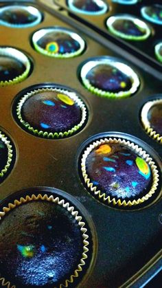 the muffin tins have been filled with blue and yellow frosting