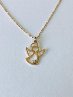 This angel charm necklace is the perfect addition to any outfit.You can layer it with your favorite necklaces or alone.14K Rose Gold Angel Necklace is solid gold. (not filled or not plated)Charm size isheigh: 14 mmwide :  10 mmlenght: 16'' - 17'' - 18'' inches.It has small cubic zirconia stone on it. Gold Birthstone Necklace, Angel Wings Jewelry, Mothers Day Rings, Gold Heart Ring, Angel Charm, Angel Jewelry, Gold Angel, White Gold Necklace, Angel Necklace