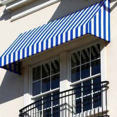 a blue and white striped awning over two windows