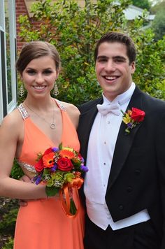 a man and woman in formal wear standing next to each other