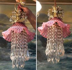 two chandeliers hanging from the ceiling, one in pink and one in gold