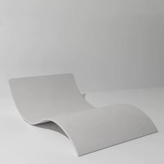 a white chair sitting on top of a white floor