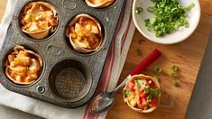 some food is in a muffin tin on a table