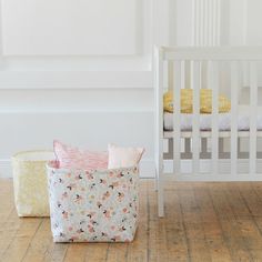 two baby cribs in the corner of a room