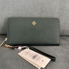 Tory Burch Emerson Zip Passport Continental Wristlet Wallet Beautiful Leather Zip Around Continental Wallet With Detachable Wrist Strap 15 Credit Card Slots, 3 Billfold Slots, And Zipper Change Pocket; Beautiful Leather With Matching Trim; Gold Tone Hardware Approximate Size: 7.75"W X 4.25"H X 1"D Style No.74179 Tan Clutch For Everyday Use, Lululemon Rectangular Wallet With Zipper Closure, Tory Burch Emerson, Tory Burch Kira Chevron Wallet, Travel Wallets With Silver-tone Hardware, Black Rectangular Wallet With Zipper Closure, Tory Burch Wallet, Coach Wallet With Zipper Closure For On-the-go, Tory Burch Bag