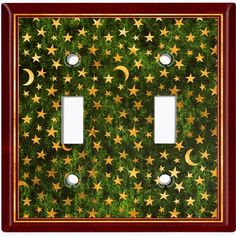 two light switch covers with stars and moon designs on green grass in the night sky