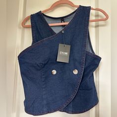 Buttons Not Functionalable, Slides Over Head, Criss Cross Style Trendy Blue Denim Vest For Workwear, Cropped Denim Top For Workwear, Fitted Cropped Denim Vest With Button Closure, Spring Button-up Denim Vest With Pockets, Fitted Medium Wash Denim Button-up Vest, Cotton Button-up Denim Vest With Pockets, Medium Wash Button-up Denim Vest With Pockets, Criss Cross, Slides