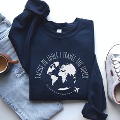 Excuse Me While I Travel The World Sweatshirt, Travel Sweatshirt, Travel Gift, Adventure Sweatshirt The unisex soft-style t-shirt puts a new spin on casual comfort. Made from very soft materials, this tee is 100% cotton for solid colors. Heather colors and sports grey include polyester. The shoulders have twill tape for improved durability. There are no side seams. The collar is made with ribbed knitting to prevent curling damage. 100% ring-spun cotton (fiber content may vary for different colors)' Gildan Sweatshirt * 50% cotton, 50% polyester * Medium-heavy fabric (8.0 oz/yd² (271.25 g/m * Loose fit * Sewn-in label * Runs true to size **Processing & Delivery Time** * Production time is usually 2 - 5 days.  Turnaround time ranges from 7-12 days. * Production time does NOT include shipping Cotton Crew Neck T-shirt For Travel, Cotton Travel Tops With Letter Print, Cotton Letter Print Travel Tops, Cotton Letter Print Tops For Travel, Casual Long Sleeve Tops For Travel, Adventure Sweatshirt, Travel Sweatshirt, Gildan Sweatshirt, Christmas Train