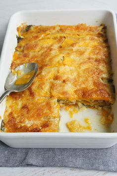 a casserole dish is shown with a spoon in it