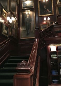 the stairs are lined with paintings and pictures