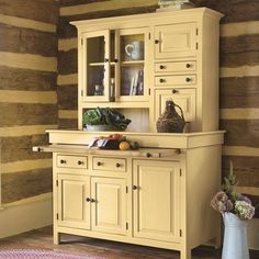 an old fashioned kitchen with wood paneling on the walls and cabinets in yellow color