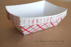 four white and red paper plates stacked on top of each other