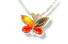 Embrace the feeling of lightness that this 925 sterling silver and Baltic amber butterfly pendant provides. This refined pendant captures the beauty of butterflies and the unique shine of amber. Material: 925 sterling silver Stone: Genuine Baltic Amber Stone dimensions: 2x 8x3, 2x 5x3 mm Item dimensions: 1.5 x 1.3 cm Color: Available in 2 colors. One is more orange while the other is more brown. Amber is a fossilized resin dating back millions of years. Amber is known for its beneficial properti Sterling Silver Butterfly Necklace For Formal Occasions, Formal Sterling Silver Butterfly Necklace, Orange Butterfly Jewelry For Gifts, Orange Butterfly Jewelry Gift, Orange Butterfly-shaped Jewelry Gift, Small Butterfly, Divine Timing, Art Deco Pendant, Amber Stone