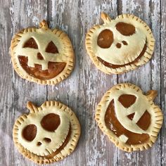 four pumpkin pies with faces carved into them