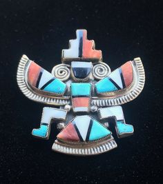 "Vintage Large Native American Old Pawn ZUNI Signed Jewelry, Sterling Silver Inlay Knifewing Kachina Brooch This incredible figure is a hand crafted Zuni Kachina brooch. The Zuni artists are known for their outstanding mosaic inlay jewelry. The piece is signed on back \"NZR\". This large circa 1950's Knifewing is inlaid with turquoise, jet, mother of pearl and coral bevel set in sterling silver. Very good vintage condition. The closure is a locking c-clasp. The signature is unidentified. Measure Unique Multicolor Collectible Brooches, Unique Multicolor Multi-stone Brooches, Character Symbols, Mosaic Inlay, Inlay Jewelry, Vero Beach Fl, Zuni Jewelry, Vero Beach, Jewelry Sterling Silver