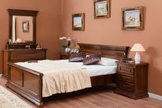 a bed room with a neatly made bed and dressers