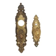 two ornate brass door handles on a white background