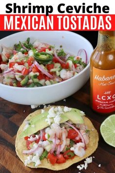 a mexican tostada with shrimp, onions and cilantro in the background