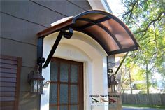 a brown awning on the side of a house next to a door and window