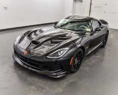 a black sports car parked in a garage