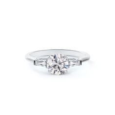 a three stone engagement ring with baguettes on the side