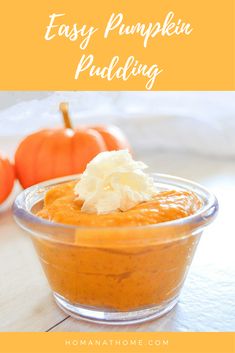 an easy pumpkin pudding in a glass bowl with whipped cream on top and two mini pumpkins behind it