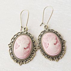 Lady silhouette cameo earrings. This lovely yet rose cameo earrings are just divine. This lovely piece of jewelry measures to fit a 25x18 mm cameo and comes with great antique toned french hook style dangle earrings. These gorgeous earrings measure 1 3/4 inches in length and would be the perfect gift for you or someone special. Cameo necklace: https://www.etsy.com/listing/500220724/pink-cameo-necklace-silver-letter?ref=shop_home_active_9&pro=1&frs=1 Cameo bracelet: https://www.etsy.com/listing/6 Cameo Earrings For Gift, Antique Cameo Earrings Gift, Antique Cameo Earrings As Gift, Antique Cameo Earrings For Gift, Vintage Cameo Drop Earrings, Victorian Cameo Earrings For Gift, Cameo Brass Jewelry, Antique Pink Earrings Gift, Victorian Style Pink Earrings For Gift