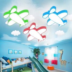 a child's bedroom with blue walls, green carpet and white clouds painted on the ceiling