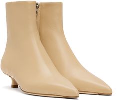 Ankle-high LWG-certified grained nappa leather boots in beige. · Pointed toe · Zip closure at inner side · Red stitch at heel tab · Grained lambskin lining · Kitten heel with rubber injection · Nubuck sole with rubber injection · Heel: H1.25 Supplier color: Latte Beige Leather-lined Pointed Toe Boots, Beige Pointed Toe Boots With Leather Lining, Cream Pointed Toe Calf Leather Boots, Cream Pointed-toe Calf Leather Boots, Cream Calf Leather Boots With Reinforced Heel, Beige Calf Leather Boots With Reinforced Heel, Cream Round Toe Heeled Boots In Calf Leather, Beige Calf Leather Heeled Boots With Round Toe, Cream Calf Leather Heeled Boots With Round Toe