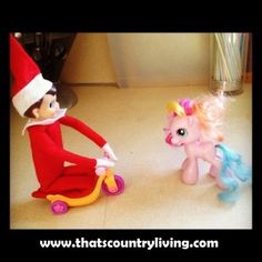 an elf and pony toy sitting on the floor next to each other