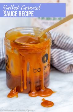 a jar filled with caramel sauce on top of a table next to a bottle