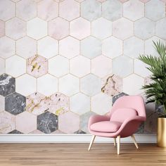 a pink chair sitting in front of a wall with hexagonal tiles on it