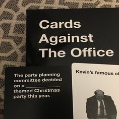 two cards against the office sitting on top of a bed