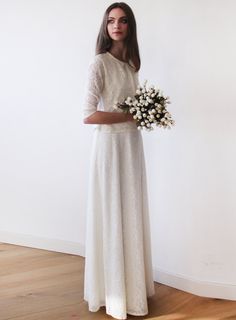 a woman in a white dress holding a bouquet of flowers