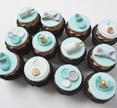 there are many cupcakes that have blue icing and gold decorations on them