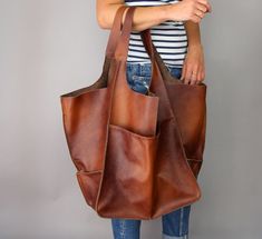 "Roomy leather shopping bag. Cognac brown oversized bag. Oversized bag - large leather tote bag. Large and stylish tote bag made from high quality leather. Spacious interior provides room for all the daily essentials and more. It is large enough to hold all your weekend essentials. This bag is perfect as your everyday bag, which can fit an IPAD, A4 files, books, magazines, cosmetic bag as well as many accessories. * Includes internal pockets for mobile phone and other small items. * Top closure Brown Tote Weekender Bag With Pockets, Brown Weekender Bag For Shopping, Brown Hobo Bag With Pockets For Shopping, Large Brown Leather Shoulder Bag, Brown Leather Hobo Bag With Pockets, Brown Weekender Bag With Leather Handles For Shopping, Brown Tote Weekender Bag For Errands, Tote Bag With Pockets, Slouchy Tote