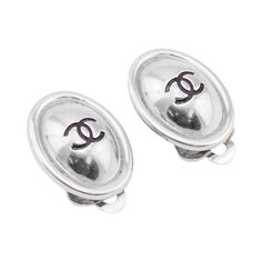 Chanel clip on earrings from the Spring 1999 collection. Silver tone metal oval with engraved interlocking logo in centre. Brand and date plaque on back. The silver is a great alternative to the mostly gold tone Chanel jewellery. Excellent vintage condition. Made in France. 0.75" x 0.5" Luxury Silver Jewelry With Silver-tone Logo Plaque, Chanel Jewellery, Chanel Spring, Chanel Earrings, Chanel Jewelry, Art Deco Interior, Cc Logo, Vintage Silver, Clip On