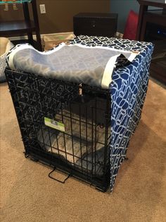 a dog in a crate on the floor