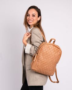 Introducing the Bekema leather backpack, expertly crafted from premium quality leather to meet the highest standards of durability and style. Featuring a soft diamond patterned texture, it exudes refined elegance.The clean lines and understated design make it perfect for those who appreciate a minimalist approach to fashion. PRODUCT DETAILS Dimensions: 10.2" L x 3.5" W x 14.2" H Material: Premium Leather Closure: Zipper Compartments: 2 Pockets / inside: 1 (1 zippered ) Strap handle drop: 8.7" Sh Classic Textured Leather Backpack For On-the-go, Versatile Quilted Leather Bag, Quilted Backpack For Daily Use, Quilted Standard Backpack For Daily Use, Classic Everyday Quilted Bag, Quilted On-the-go Backpack, Luxury Backpack With Textured Leather For Daily Use, Quilted Leather Backpack For Everyday Use, Luxury Quilted Backpack For Travel