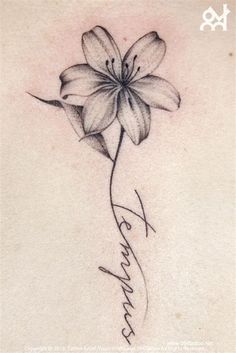 the back of a woman's neck with a flower on it and her name written in cursive writing