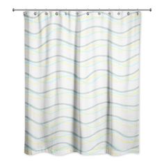 a white shower curtain with blue and yellow wavy lines on the bottom, in front of a