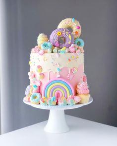 there is a cake that looks like it has been decorated with rainbows and unicorns