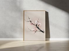 an art print on a wall with a tree branch in blossom