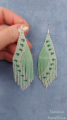 These handmade author's earrings are made of high-quality Czech beads and strong synthetic thread. In these unique earrings I use my author's scheme (Abstract minimalism). They are elegant, fashionable, and highly versatile, suitable for everyday wear. Color: pastel green(mint),emerald. 100% hand made with love! Measurements: Length- near 10.5cm(3.94inch),Width -3 cm(1.18 inch) Materials: Sterling silver components Czech glass beads Tytan Thread Thank looking on my work! Adjustable Green Tassel Earrings For Summer, Green Dangle Tassel Earrings For Summer, Green Tassel Drop Earrings As Gift, Adjustable Green Chandelier Earrings With Dangling Beads, Handmade Green Beaded Dangle Earrings, Handmade Green Dangle Beaded Earrings, Unique Green Beaded Earrings, Green Handmade Dangle Chandelier Earrings, Handmade Green Tassel Earrings For Gift