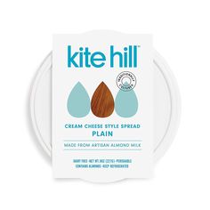 a package of kitte hill cream cheese style spread on a white plate with blue and brown drops