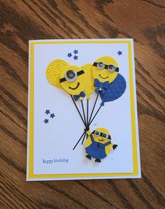 a happy birthday card with two minions holding balloons