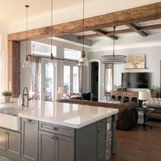 a large kitchen with an island in the middle and lots of counter space on one side