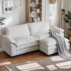 a living room with a white couch and rugs in front of a book shelf