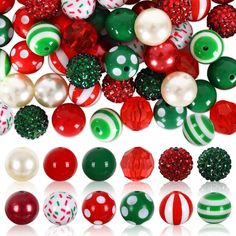 many different colored balls and ornaments on a white surface