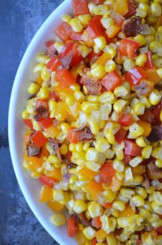 a white bowl filled with corn and sausage